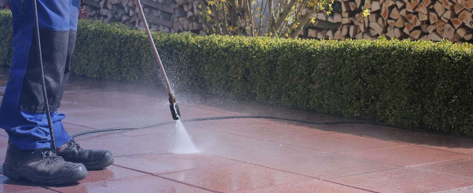Man pressure washing patio tiles - Bristol Pressure washing (Bristol Patio Cleaning)