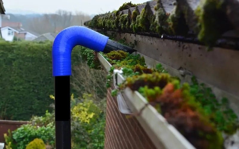 Gutter being cleaned by a tool- Bristol Pressure Washing