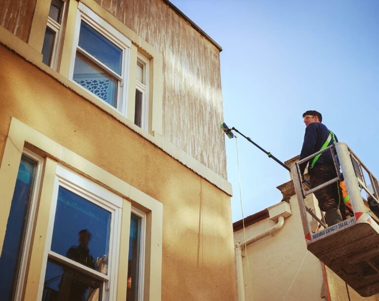 A man cleaning high windows - Bristol Pressure Washing